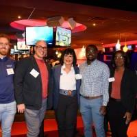 Five alumni standing with President Mantella.